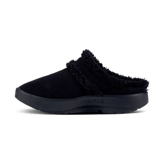 Black fuzzy mule clog with a thick platform sole and a closed toe, side view