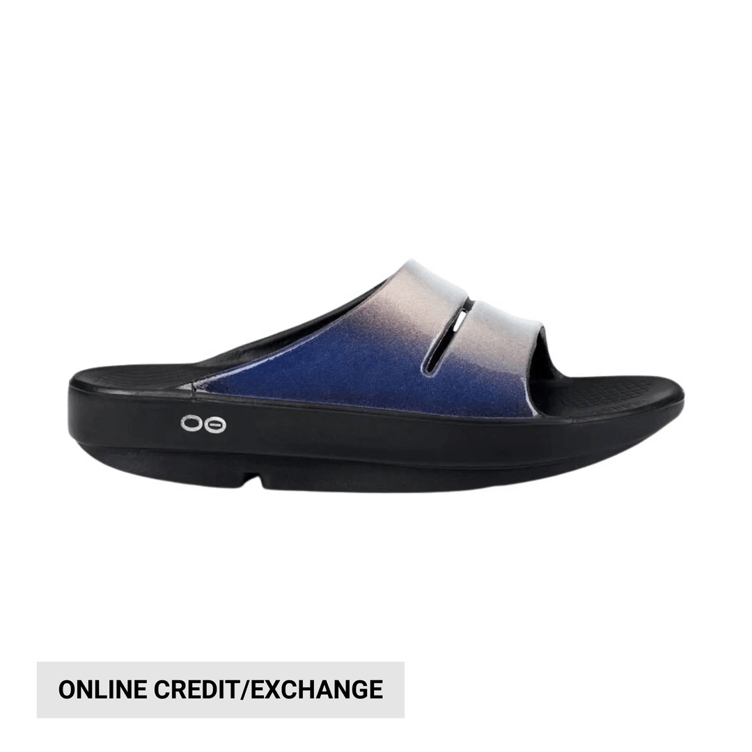 Blue-to-gray slide sandal with a black cushioned sole and side logo