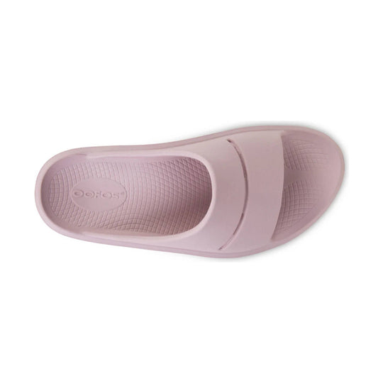 Light pink slide sandal with textured footbed and OOFOS logo on the sole