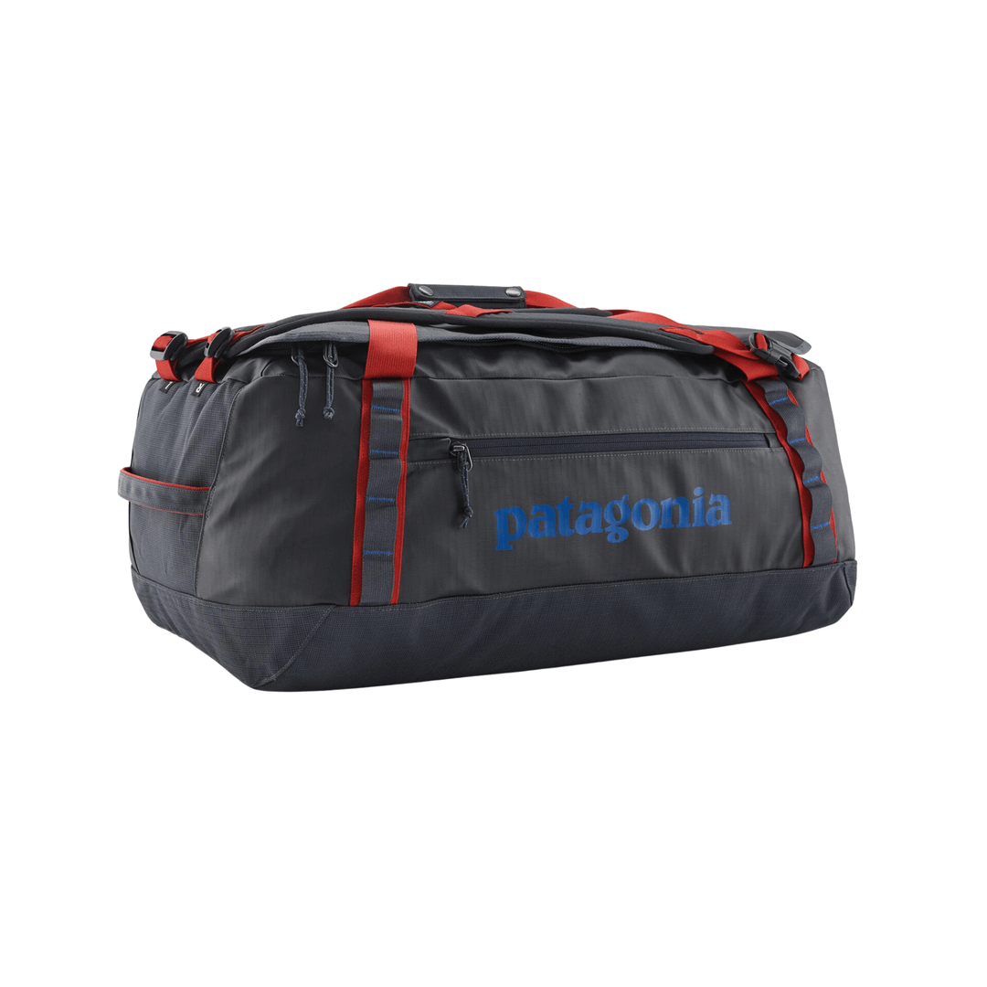 Dark duffel bag with red straps and blue logo, shown in side view