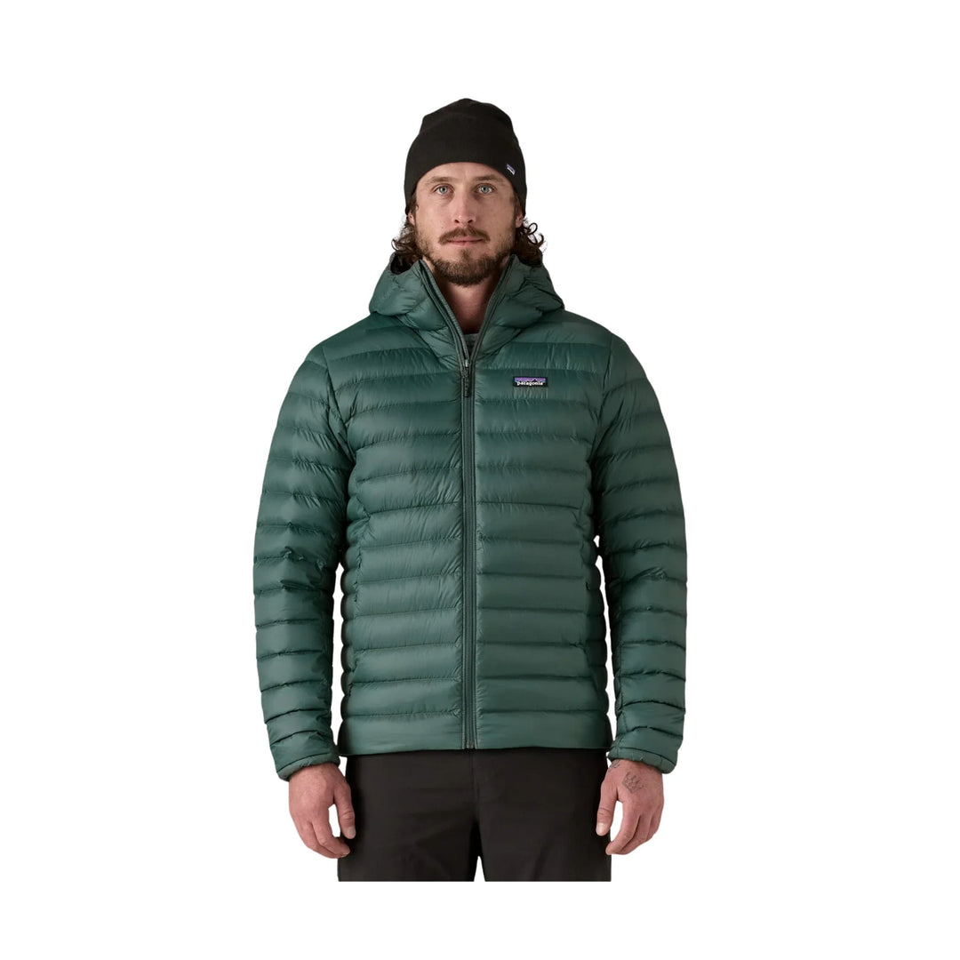 Dark green hooded puffer jacket with front zipper and Patagonia logo patch