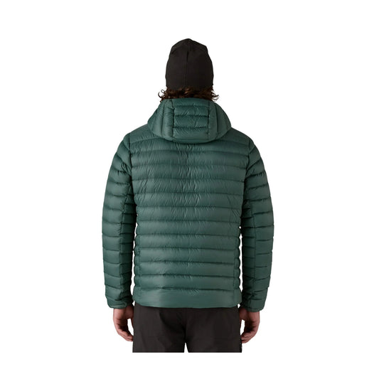 Green hooded puffer jacket shown from the back
