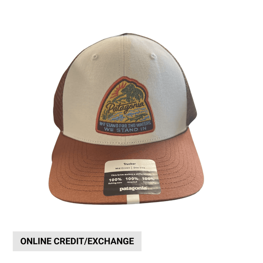 Two-tone trucker hat with embroidered front patch and hang tag reading ONLINE CREDIT/EXCHANGE