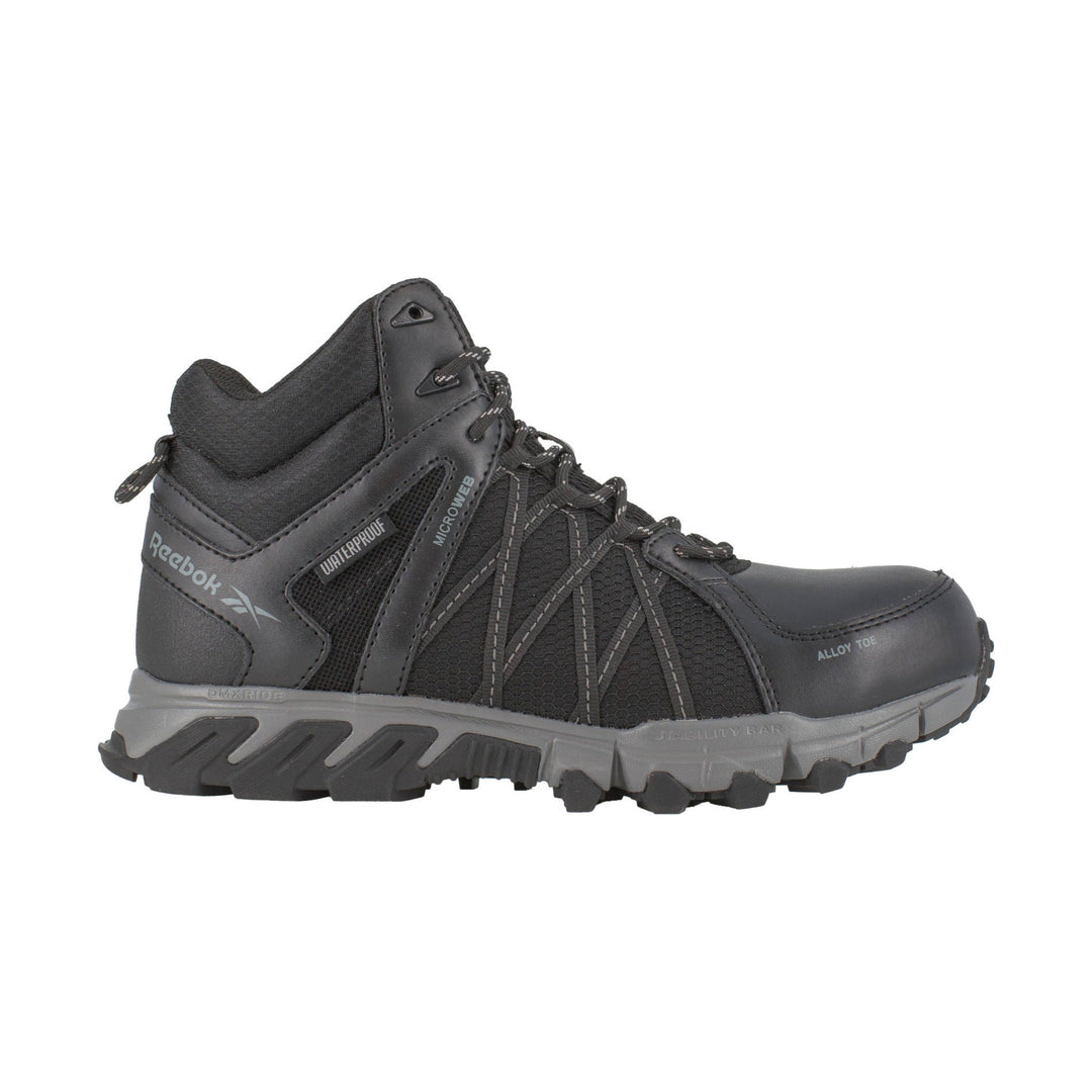 Black mid-top work boot with mesh panels, lace-up front, gray sole, and visible Reebok branding