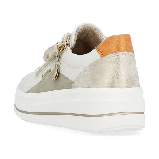 Low-top sneaker in off-white and beige with an orange heel panel, platform sole, and side charm detail