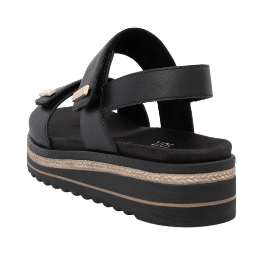 Black platform sandal with crisscross straps and gold buckle details