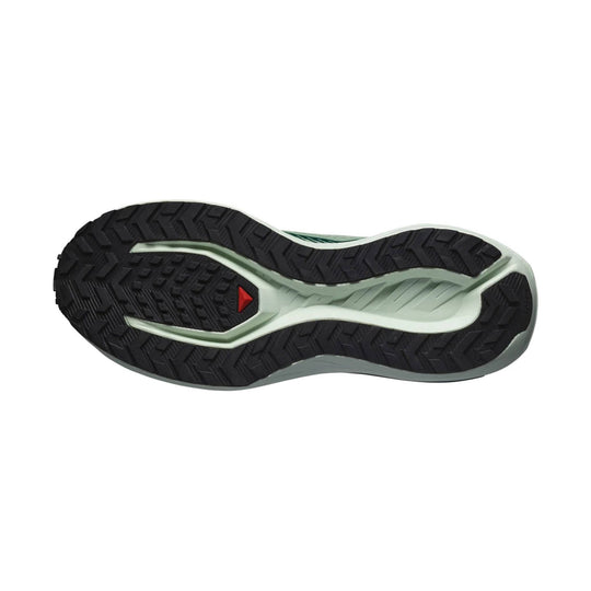 Black running shoe outsole with a pale green midfoot section and red triangular accent