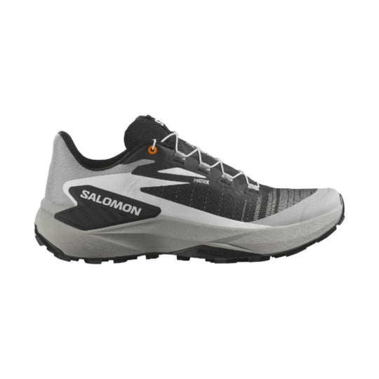 Black, white, and gray trail running shoe with white laces and a thick lugged sole