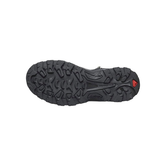 Black rugged hiking boot outsole with deep lugs and red heel accent