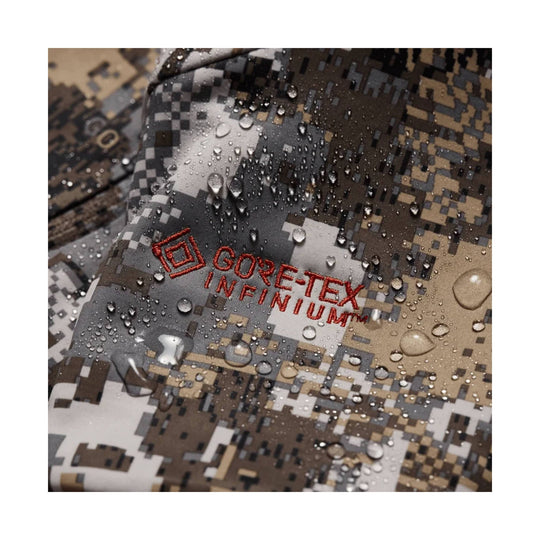 Camo jacket fabric with red GORE-TEX INFINIUM embroidery and water droplets