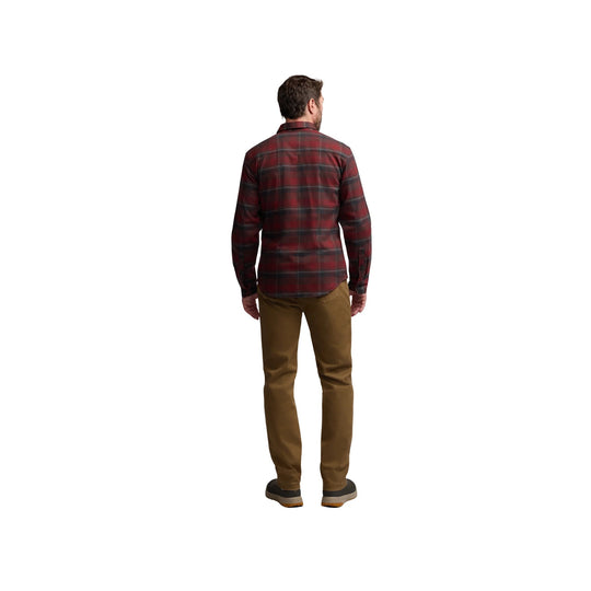 Man wearing red plaid long-sleeve shirt, tan pants, and dark shoes, shown from the back
