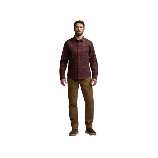 Men's red and black plaid button-up shirt with tan pants and dark slip-on shoes