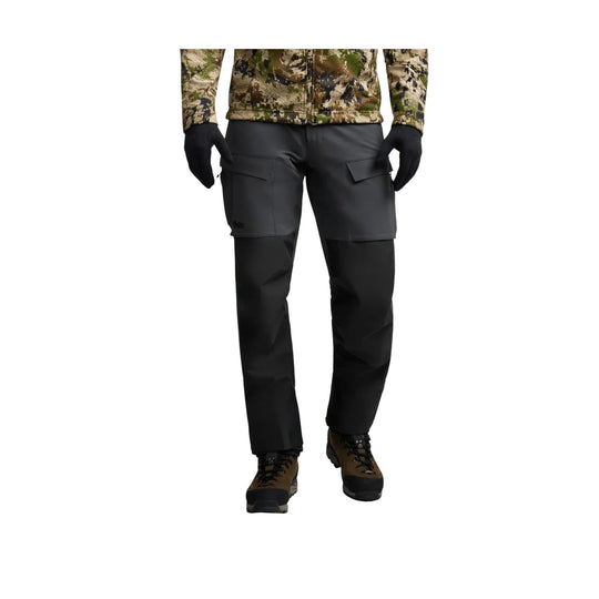 Black hiking pants with cargo pockets and articulated knees, shown with brown-and-black boots