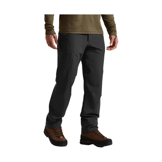 Dark gray cargo hiking pants with side pocket, shown with brown lace-up hiking boots.