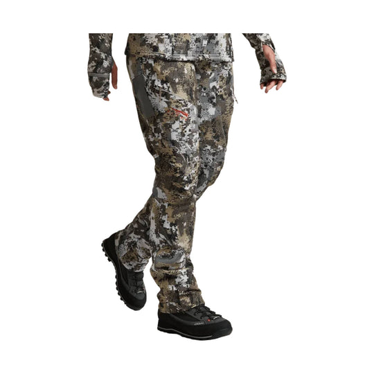 Camo hunting pants with built-in boot gaiters, shown on a model