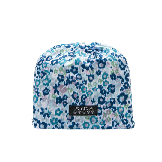 Blue and multicolor patterned knit beanie with a black SKIDA patch