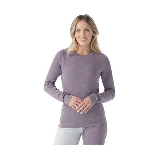 Woman wearing a long-sleeve heathered crew-neck base layer top and matching leggings