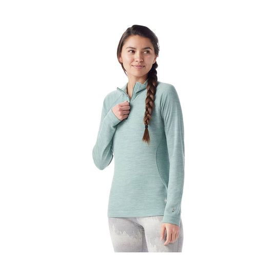 Light teal quarter-zip long-sleeve top worn with patterned leggings