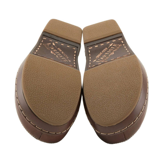 Brown clog soles with L'Artiste branding and textured tread