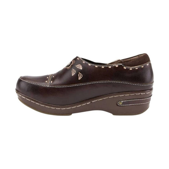 Brown closed-toe clog with stitched detailing and leaf embroidery on a platform wedge sole