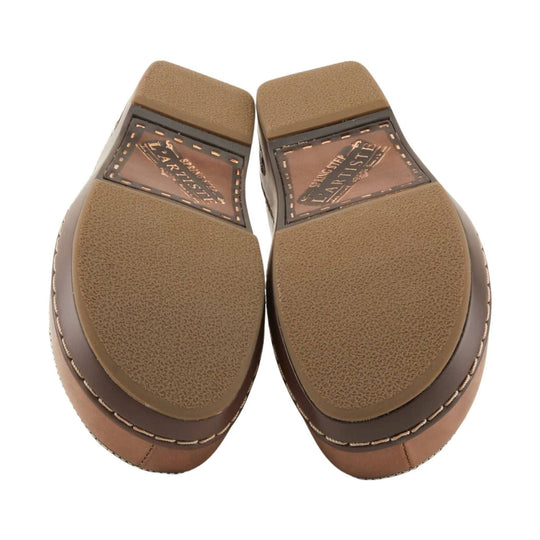 Pair of brown shoe soles with textured tread and visible L'Artiste branding