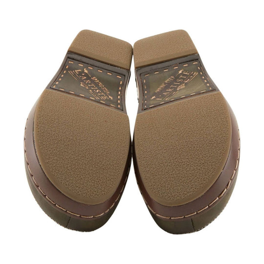 Pair of brown clog soles with textured tread and visible L'ARTISTE branding