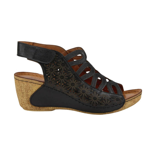 Black leather wedge sandal with floral cutouts, slingback strap, and cork-textured heel