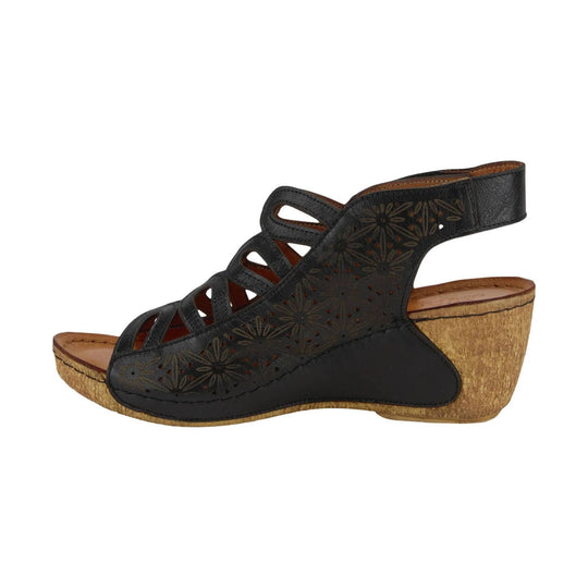 Black cutout wedge sandal with floral laser-cut detailing and a cork wedge heel