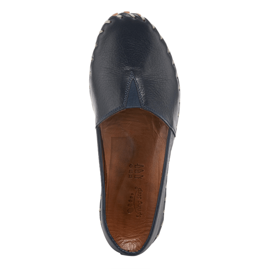 Navy leather closed-toe slip-on shoe with moccasin stitching and tan insole
