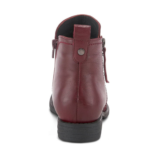 Burgundy leather ankle boot viewed from the back with side zippers and a black sole