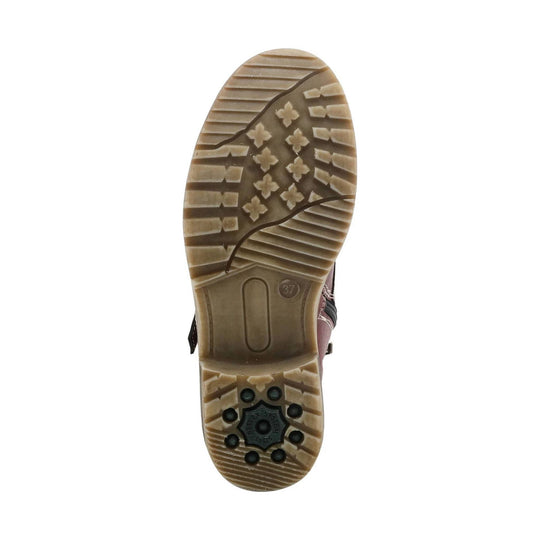 Boot sole with tan lug tread and black traction pads