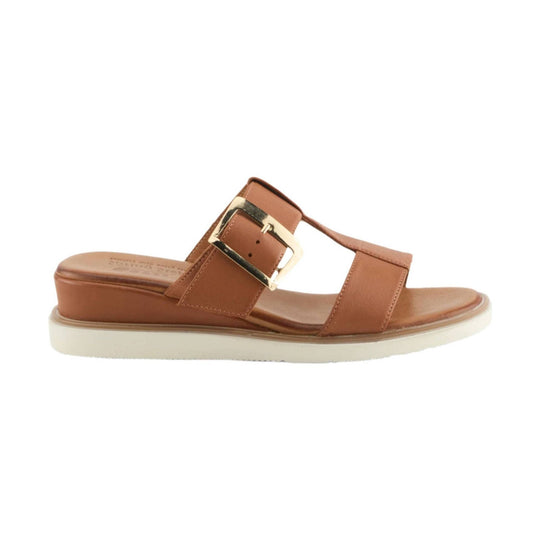 Camel leather slide sandal with wide straps, gold buckle, and white platform sole