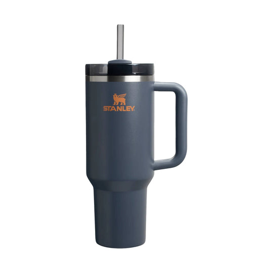 Dark blue handled travel tumbler with straw and orange Stanley logo