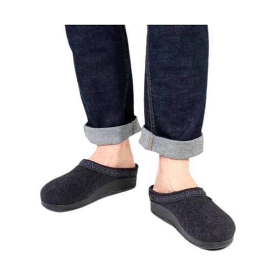 Dark wool clog slippers with rolled cuffs on a model wearing cuffed jeans