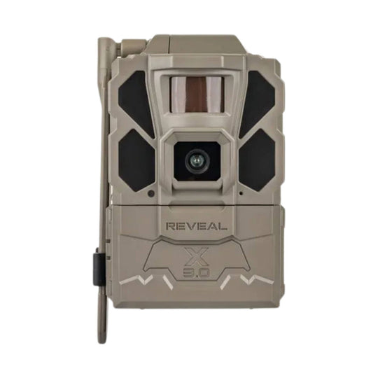 Tan trail camera with front lens, black side panels, and a side antenna