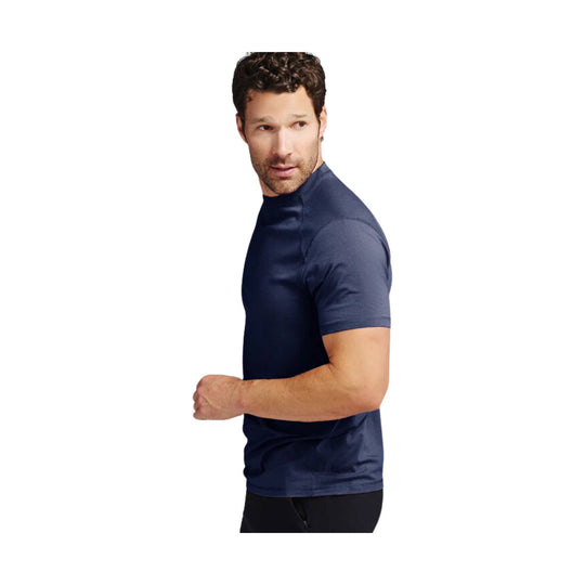Man wearing a navy short-sleeve athletic tee, shown in side profile