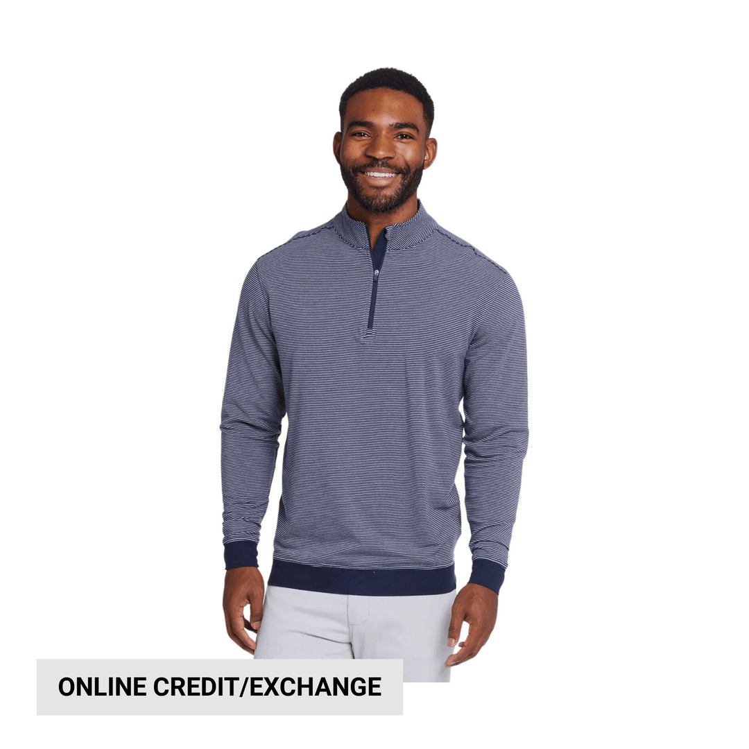Navy and white striped quarter-zip pullover worn with light pants