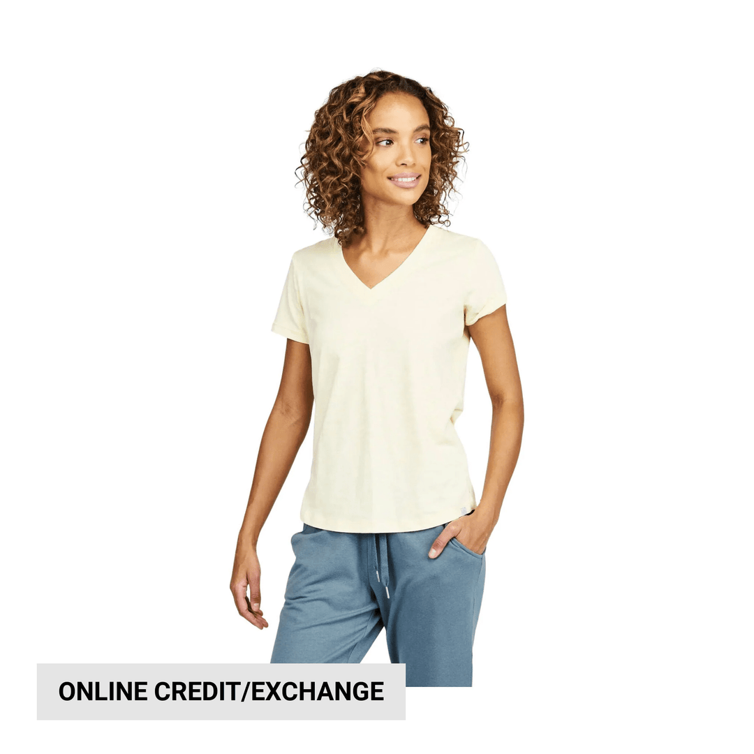 Cream short-sleeve V-neck T-shirt with a relaxed fit, shown with blue joggers