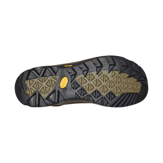 Boot outsole with black rubber tread, tan traction panels, and a yellow Vibram label
