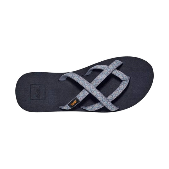 Black thong sandal with crossed patterned straps and Teva logo on the footbed