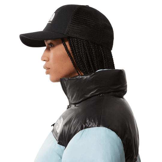 Black mesh trucker cap with a curved brim and small front patch