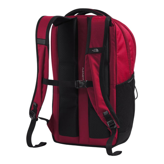 Red and black backpack shown from the back, with padded straps, chest buckle, and side mesh pocket.