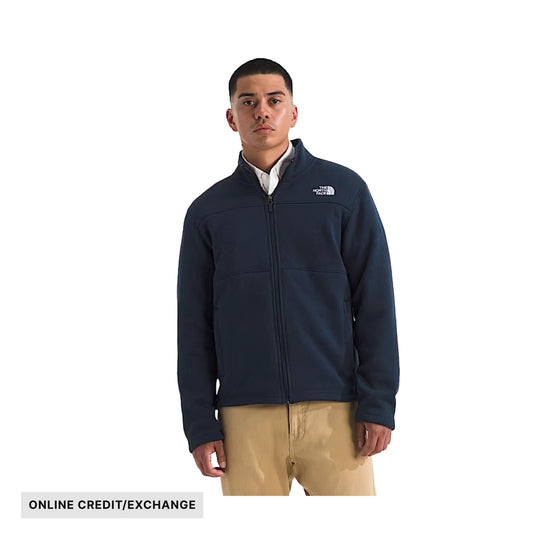Navy full-zip fleece jacket with stand collar and chest logo, worn over a white shirt