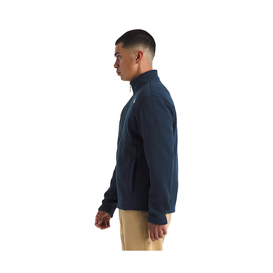 Navy full-zip jacket with high collar, chest seam details, and long sleeves, shown in side view