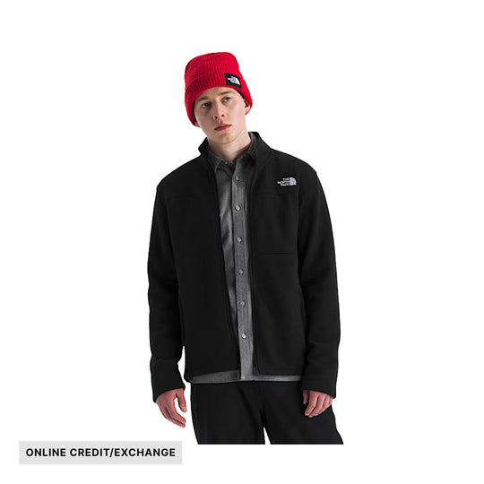 Black zip-up fleece jacket with chest logo, worn over a gray button-up shirt