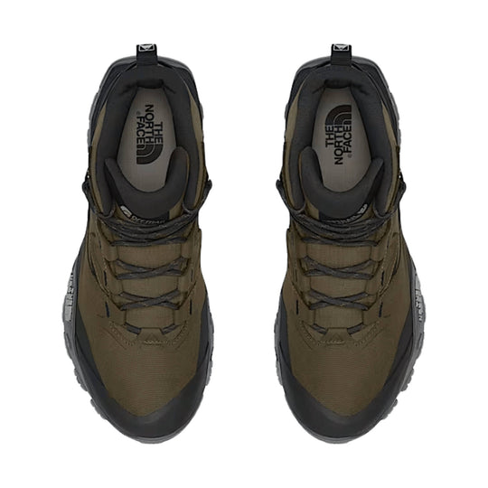 Top view of two olive and black hiking boots with thick soles and The North Face logos on the insoles