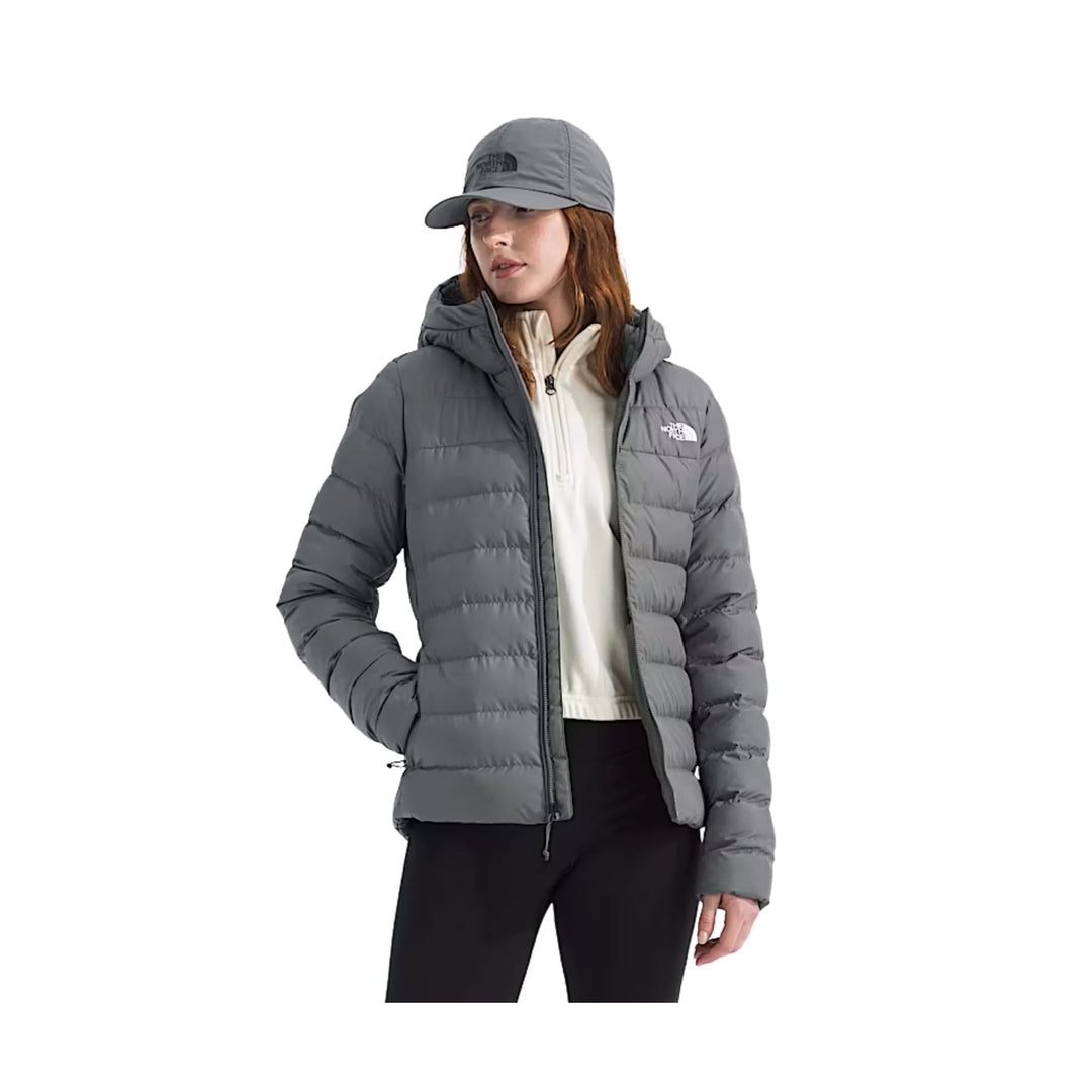 Gray hooded puffer jacket worn with a matching cap and cream quarter-zip top