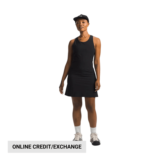 Black sleeveless athletic dress worn with a black cap and sneakers