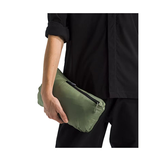 Light olive zip pouch with black zipper, held against black clothing