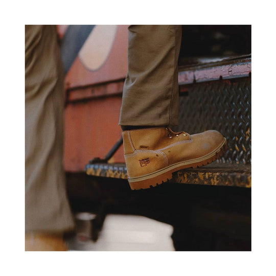 Tan leather work boot with thick lug sole and visible ankle stitching